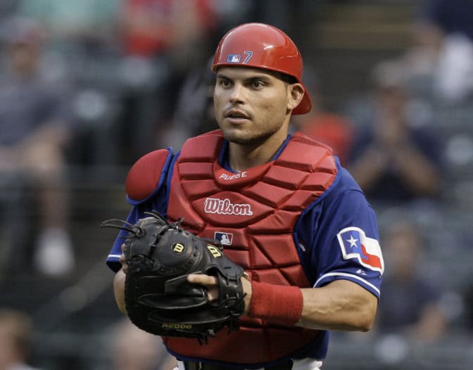 A dynamic image showcasing Ivan Rodriguez, also known as Pudge, demonstrating his exceptional defensive skills on the baseball field.